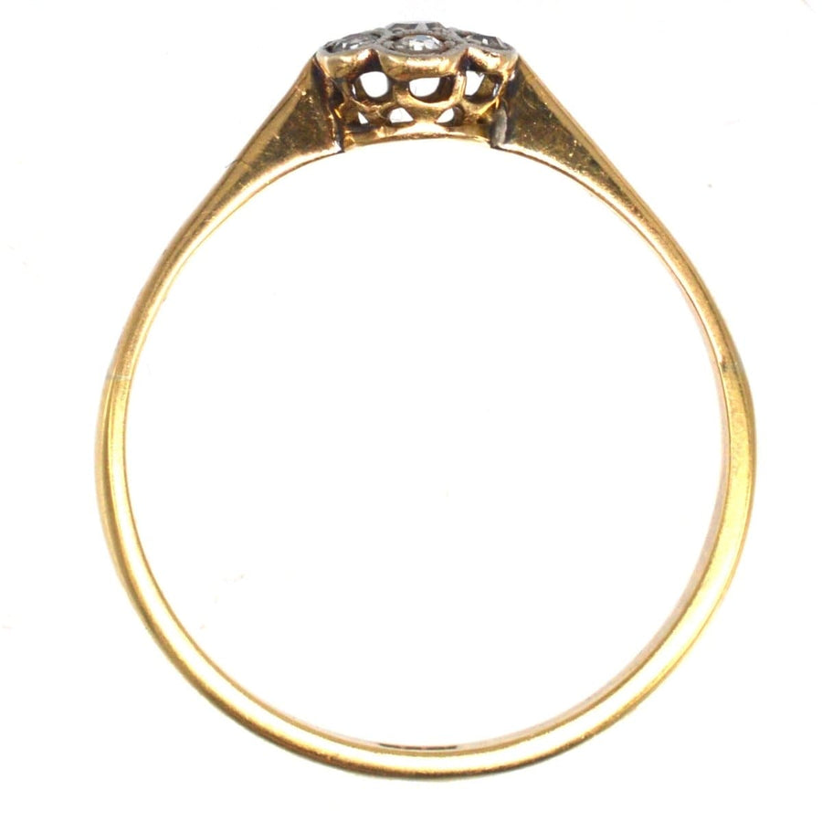 Edwardian diamond daisy cluster ring with millegrain setting, perfect for engagement.