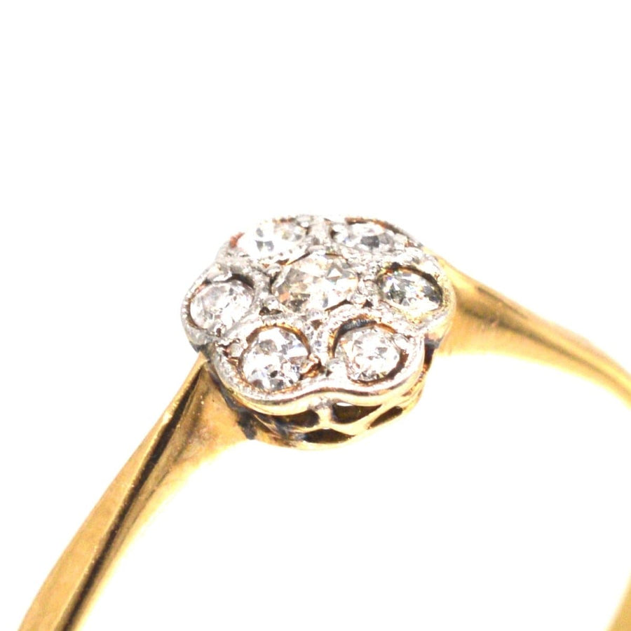 Edwardian diamond daisy cluster ring with millegrain setting, perfect as an elegant engagement ring.