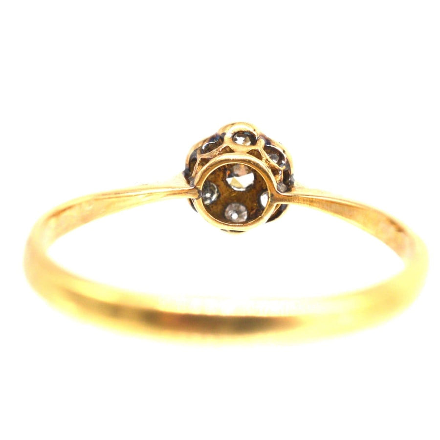 Edwardian diamond daisy cluster ring with millegrain setting, perfect for an engagement.