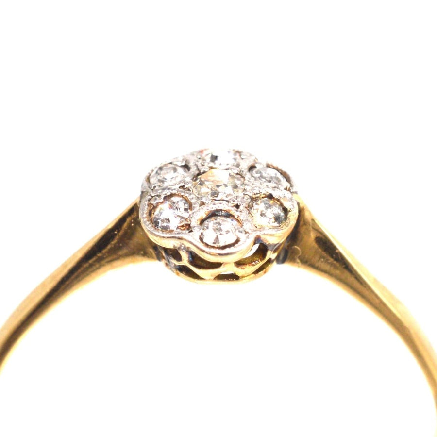 Edwardian diamond daisy cluster ring with millegrain setting, perfect for engagement or special occasions.