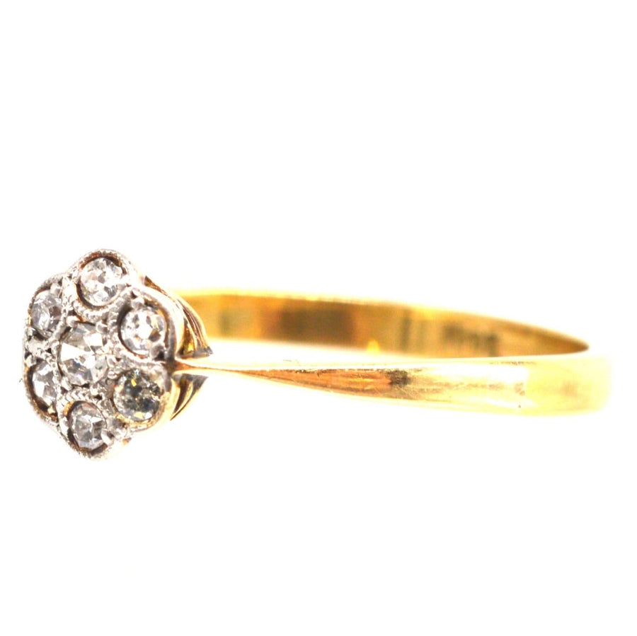 Edwardian diamond daisy cluster ring with millegrain setting, perfect for an engagement or special occasion.