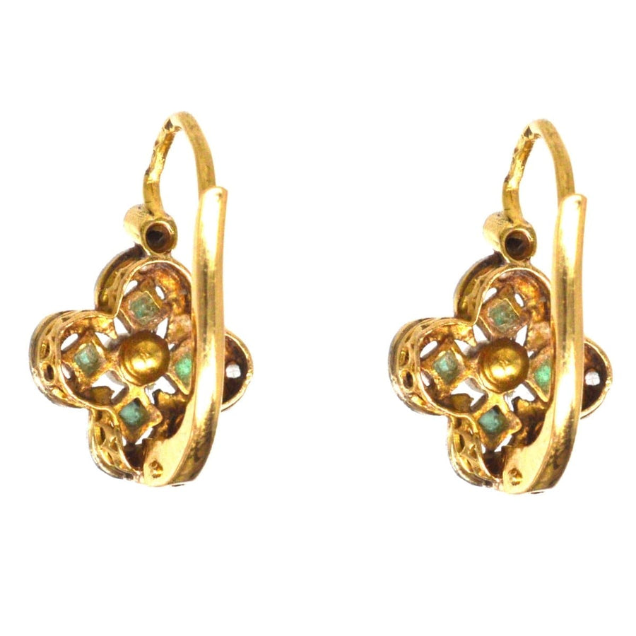 Edwardian emerald, diamond, and pearl quatrefoil earrings in gold with intricate detailing.