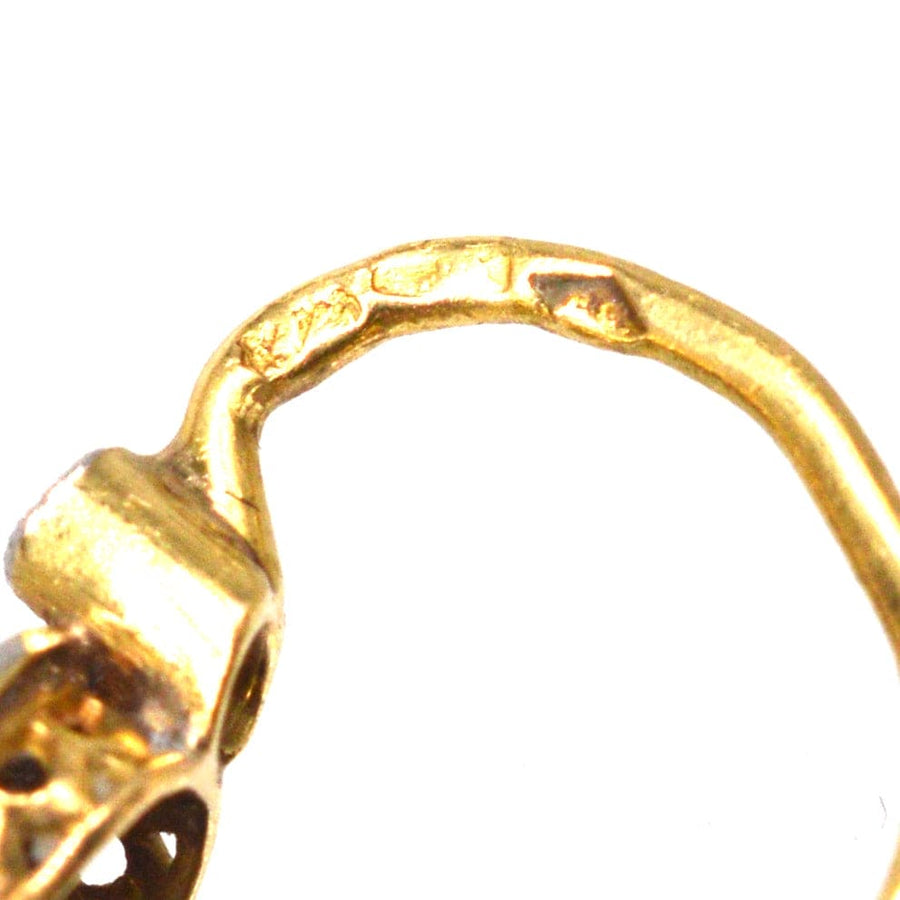 Close-up of the gold setting of Edwardian quatrefoil earrings, showcasing intricate craftsmanship and detailing.