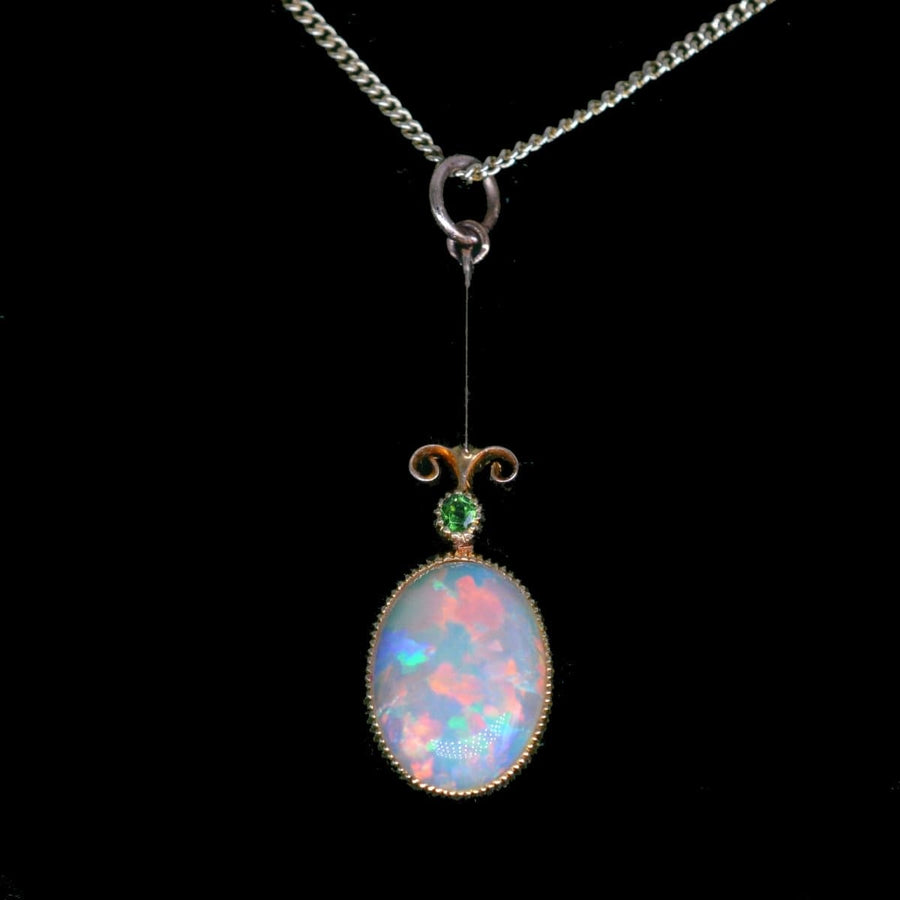 Edwardian opal pendant with green garnet on 9ct gold chain, showcasing fine antique craftsmanship.