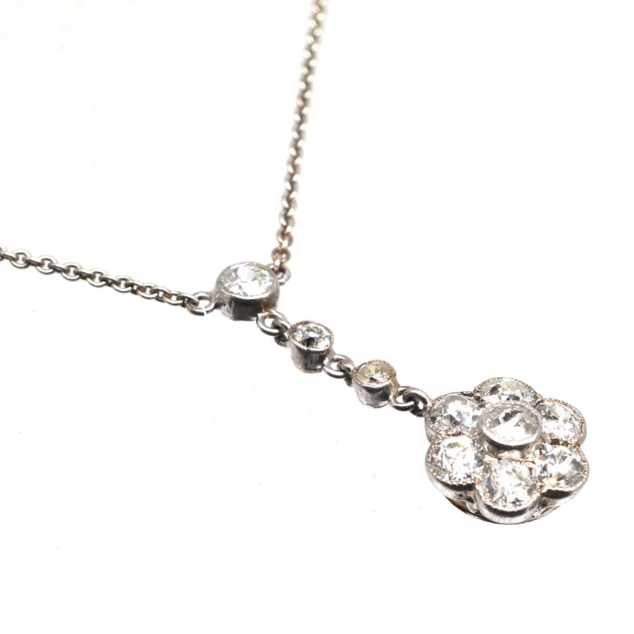 Edwardian platinum diamond cluster drop necklace with intricate design and 1.8 carats of diamonds, showcasing timeless elegance.