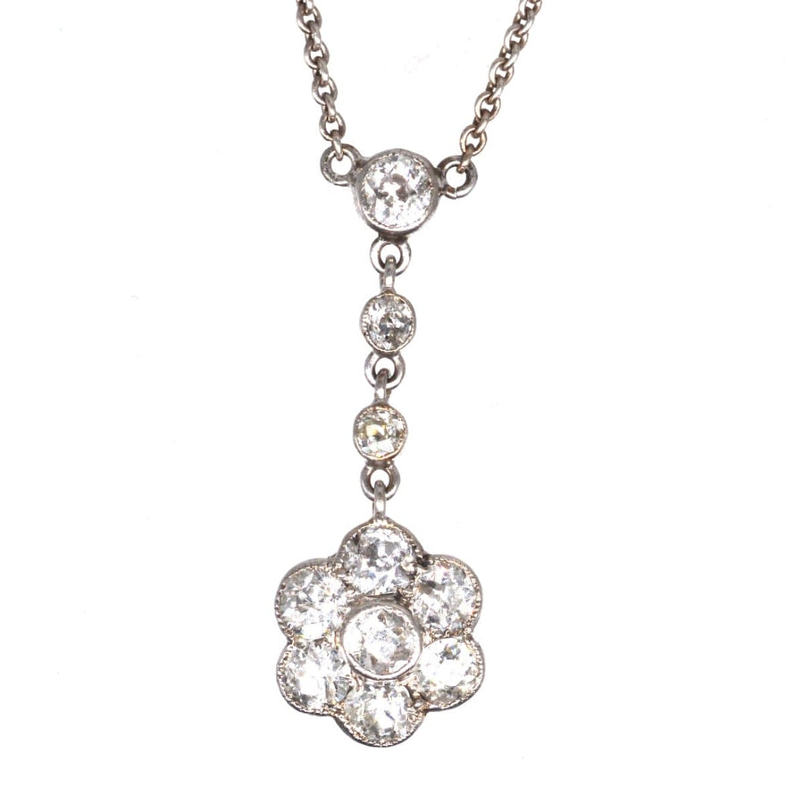 Edwardian platinum diamond cluster drop necklace featuring intricate floral design and stunning diamond accents.