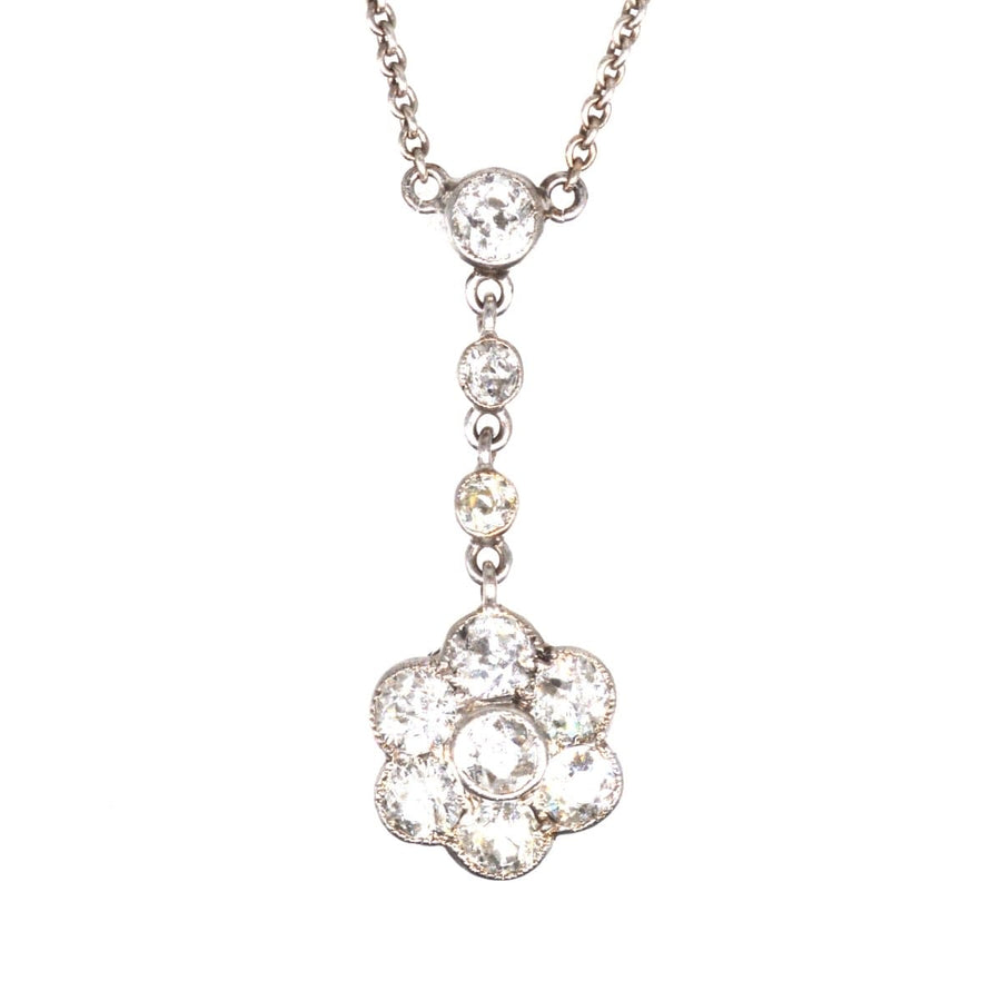 Edwardian platinum diamond cluster drop necklace featuring elegant floral design with multiple diamonds.