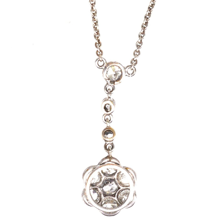 Edwardian platinum diamond cluster drop necklace with three suspended diamonds and a floral design, totaling 1.8 carats.