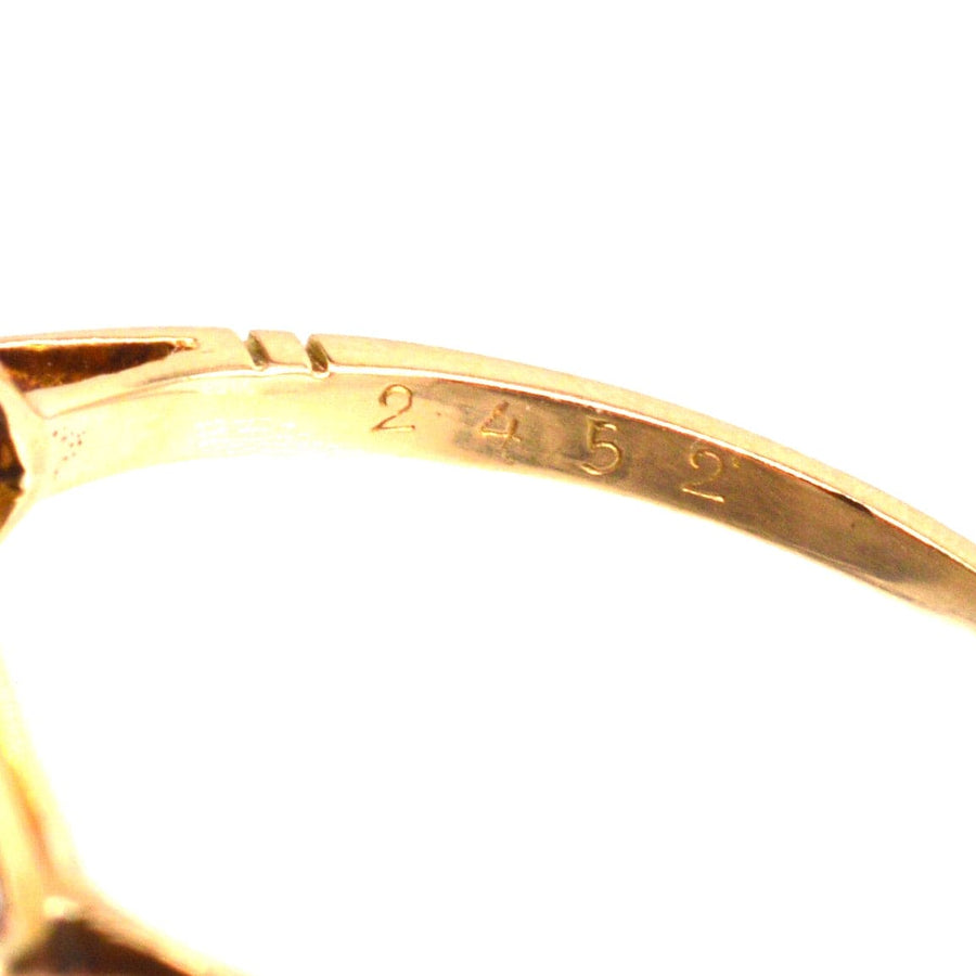 Close-up of the inner band of a French Art Deco 18ct gold ring, showing engraved markings.