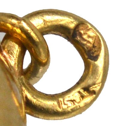Close-up of 18ct gold cufflink with a hallmark, showcasing fine French craftsmanship from the 1920s.