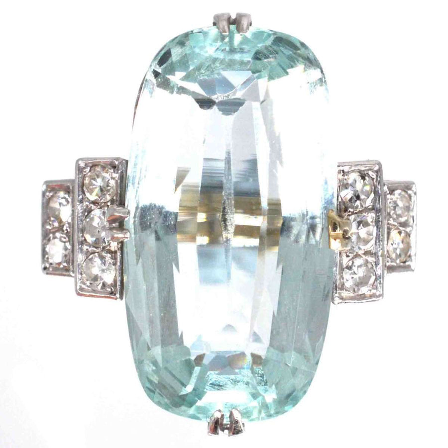 French Art Deco platinum ring featuring a 12-carat aquamarine and diamond accents, showcasing geometric elegance.