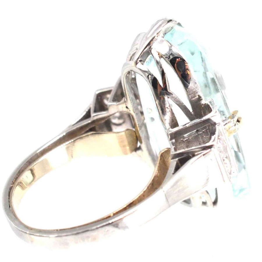 French Art Deco platinum ring featuring a 12-carat aquamarine gemstone and diamond accents from the 1930s.