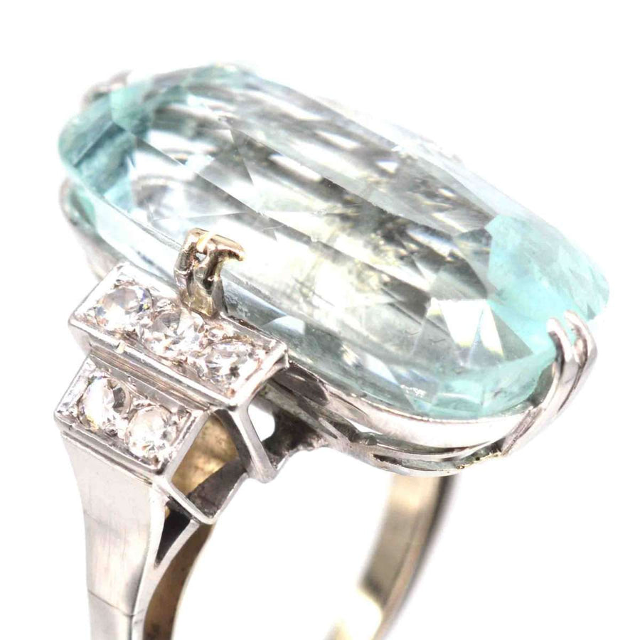 Art Deco platinum ring featuring a 12-carat aquamarine and diamond accents, showcasing elegant vintage design.