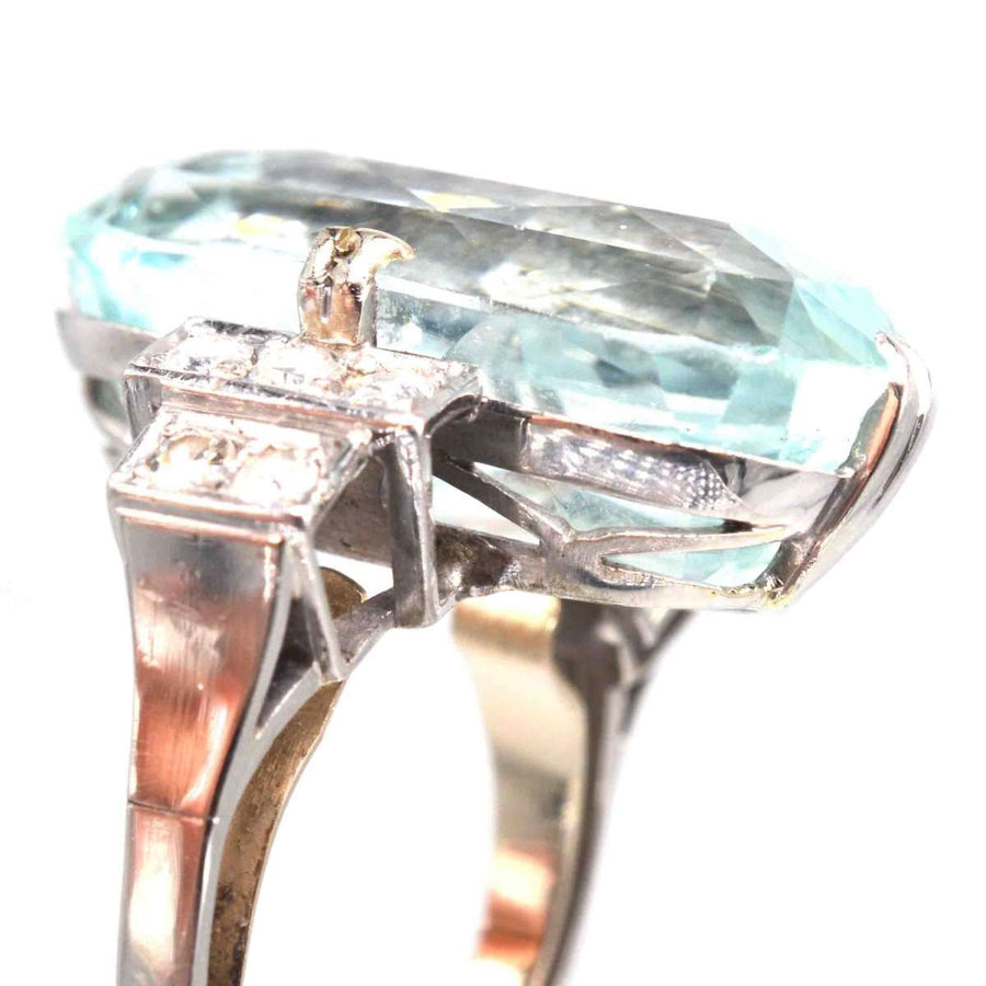 Art Deco platinum ring featuring a 12-carat aquamarine and sparkling diamonds, showcasing elegant vintage design.