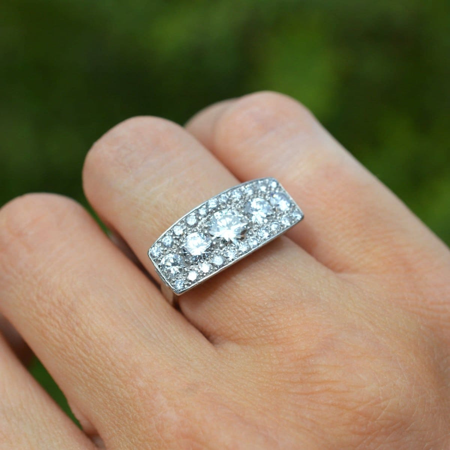 French Art Deco platinum and diamond ring on a finger, featuring over 2 carats of sparkling diamonds.