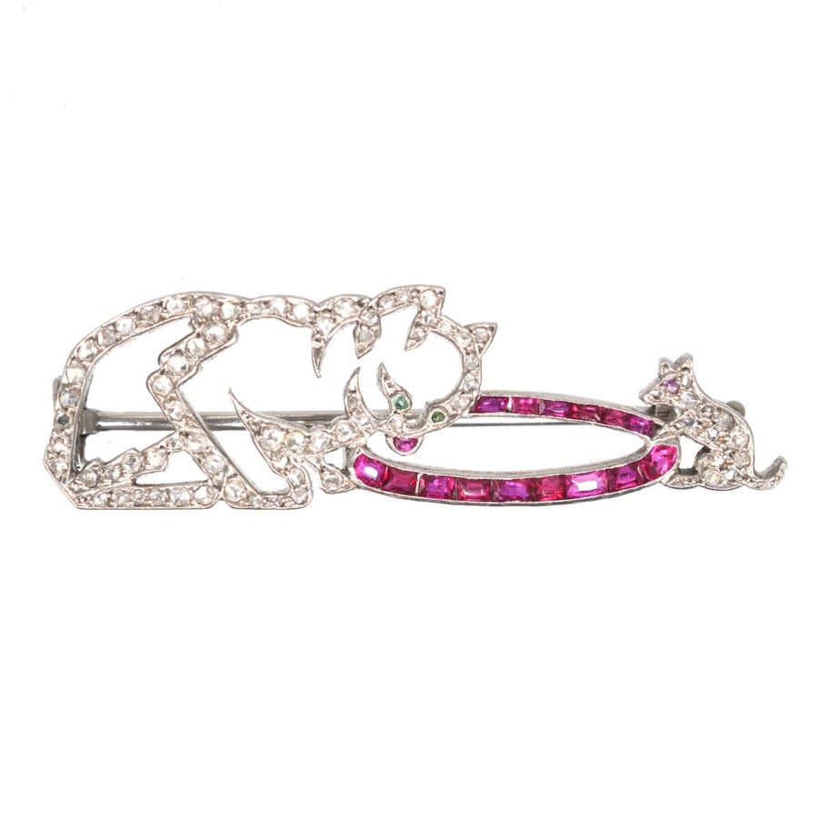 French Art Deco brooch featuring a cat and mouse, embellished with platinum, diamonds, and rubies.