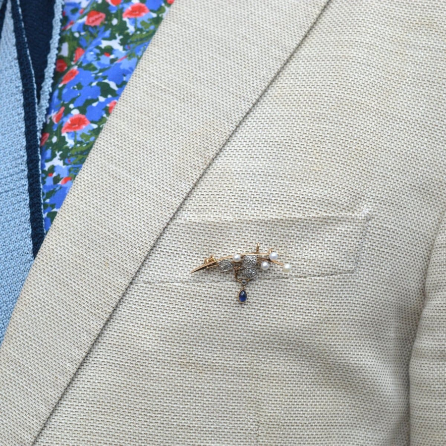 French Art Nouveau gold pearl diamond sapphire brooch pendant worn on suit lapel.