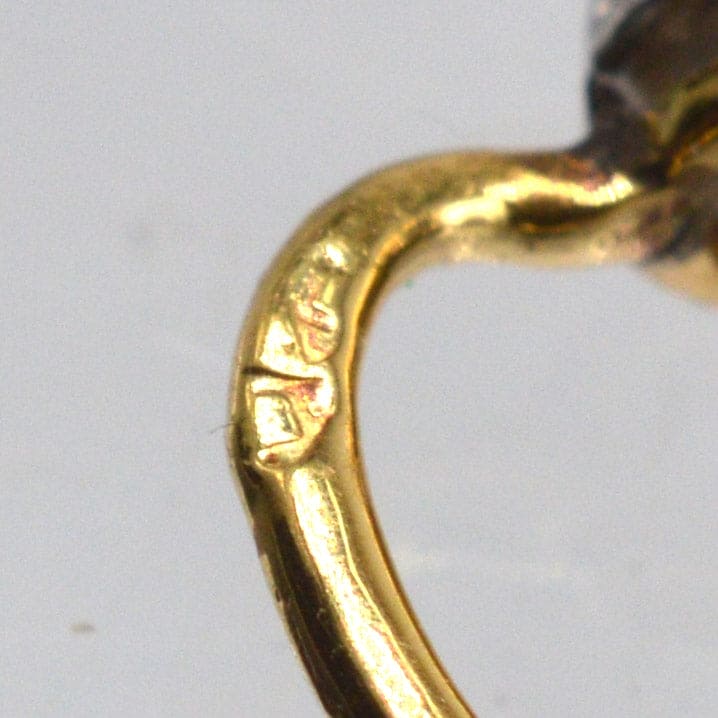 Close-up of the hallmark on a French Belle Epoque 18ct gold diamond earring for authenticity.