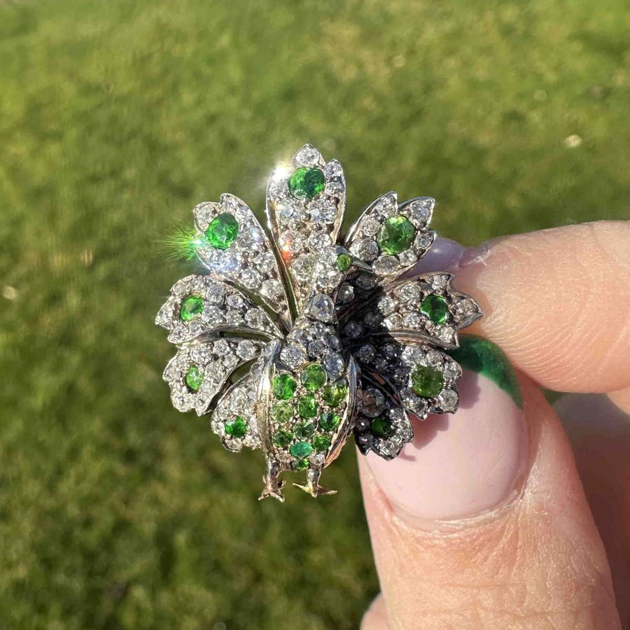 Exquisite 18ct gold peacock brooch set with demantoid garnets and sparkling diamonds, capturing the Belle Epoque charm.
