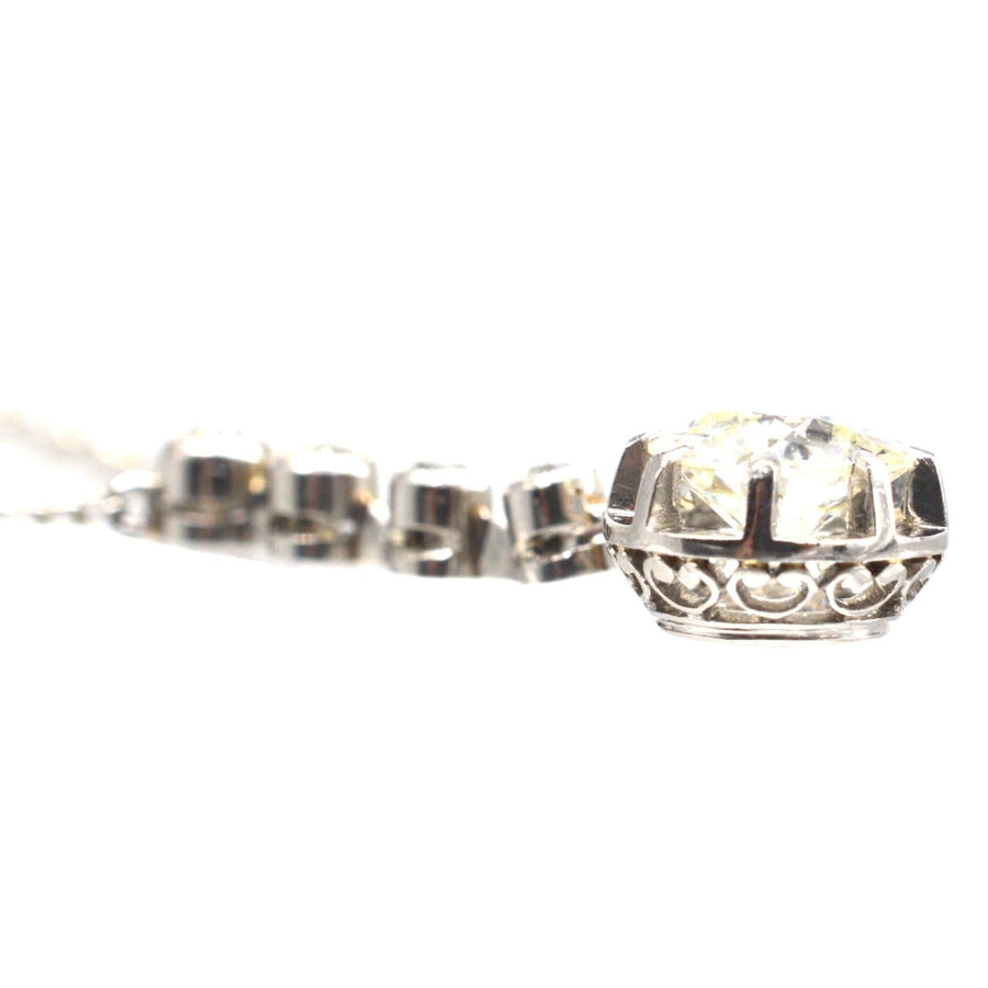 French Belle Epoque diamond drop pendant necklace in platinum and white gold, showcasing intricate claw setting.