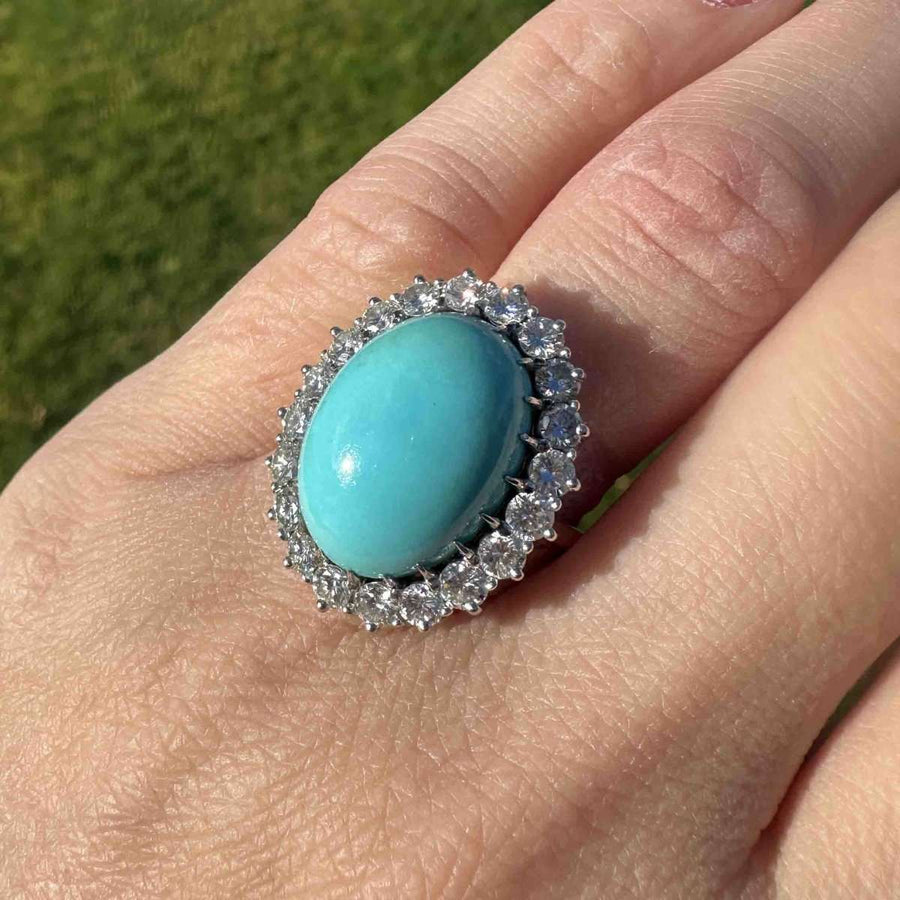 Vintage French turquoise and diamond cluster cocktail ring set in gold and platinum, showcasing a stunning oval turquoise stone.