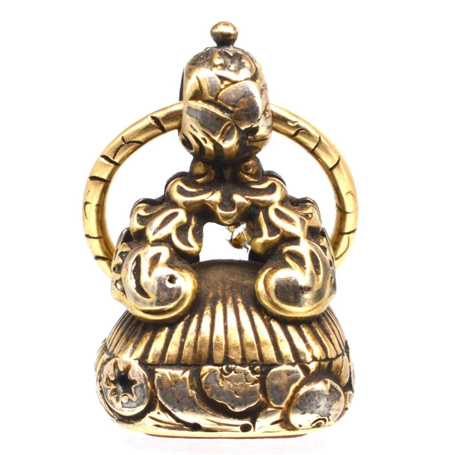 Late Georgian gold cased seal featuring intricate repousse work and split ring, circa 1820s.