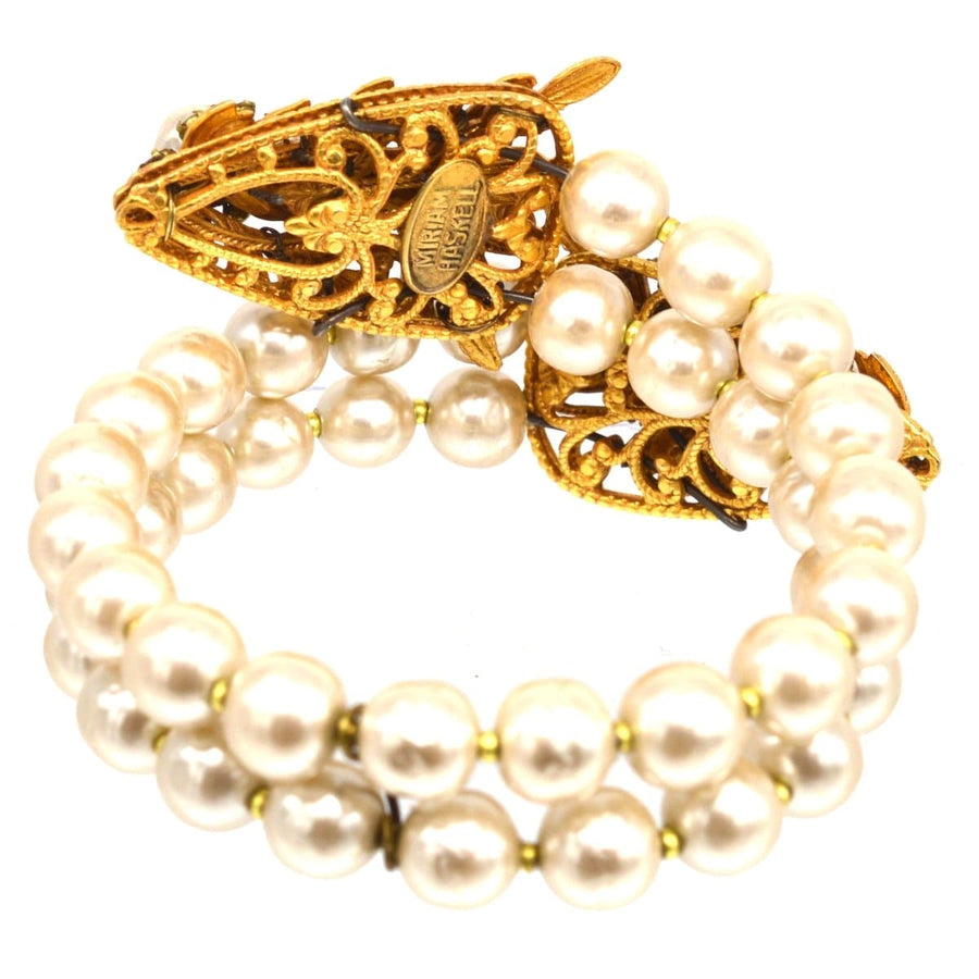 Miriam Haskell white paste and faux pearl open bangle with serpent clasp, vintage statement jewelry piece.