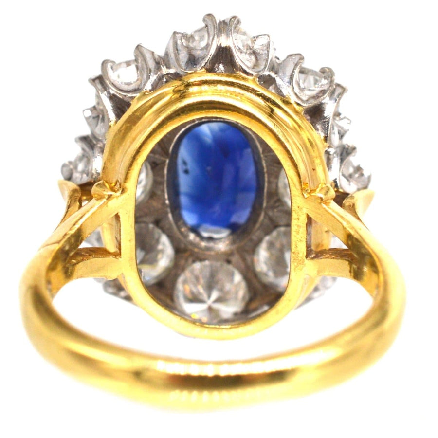 Large mid-century sapphire and diamond cluster ring featuring a 1.9 carat sapphire and 4 carats of brilliant diamonds.
