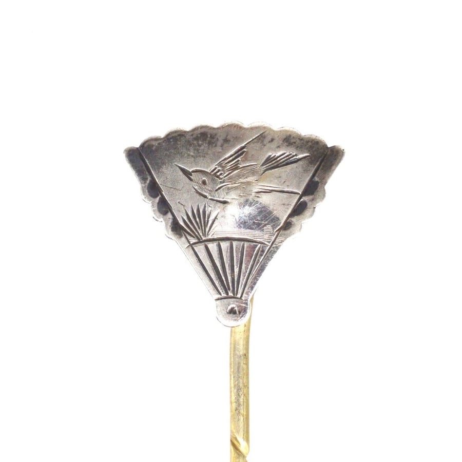 Late 19th century Aesthetic tie pin featuring a bird design on a fan-shaped silver setting.