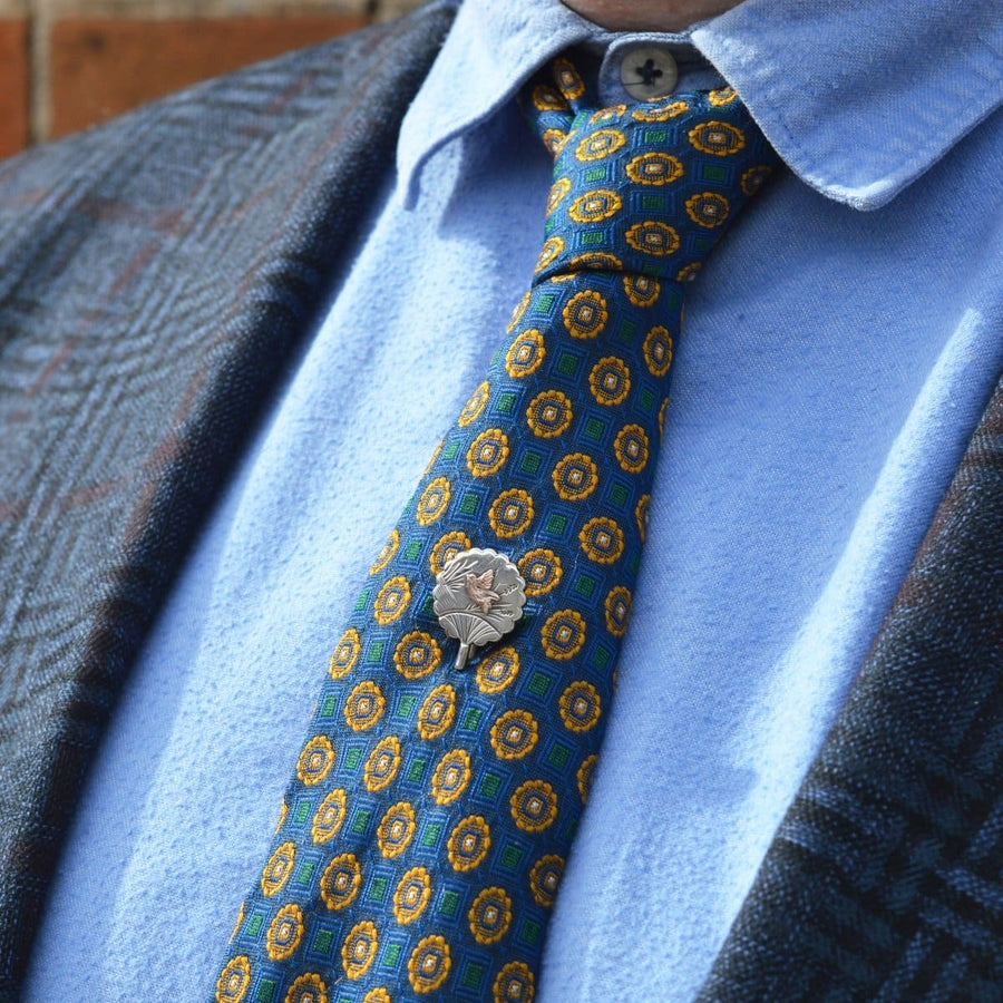 Late 19th Century Aesthetic Period bird fan tie pin featured on a patterned tie.