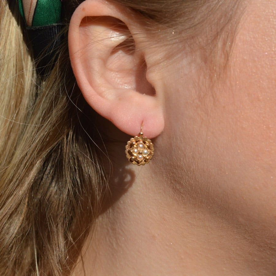 Late 19th Century French gold and pearl dormeuses earrings worn on a woman's ear.