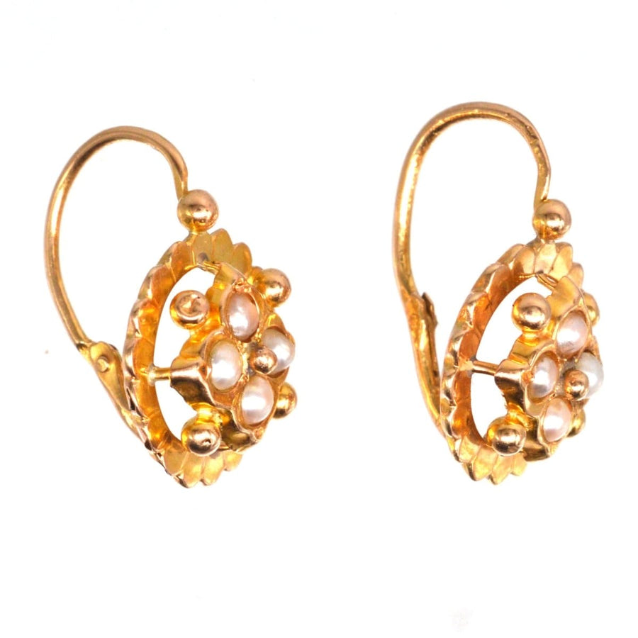 19th century French gold dormeuses earrings with split pearl clusters, showcasing vintage elegance.