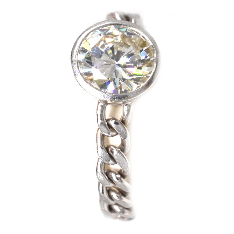 Modern 18ct white gold ring featuring a 1.8 carat brilliant cut diamond in a unique curb chain setting.