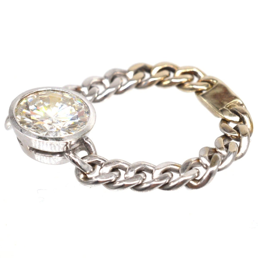 Modern 18ct white gold ring featuring a 1.8 carat brilliant cut diamond in a unique curb chain design.