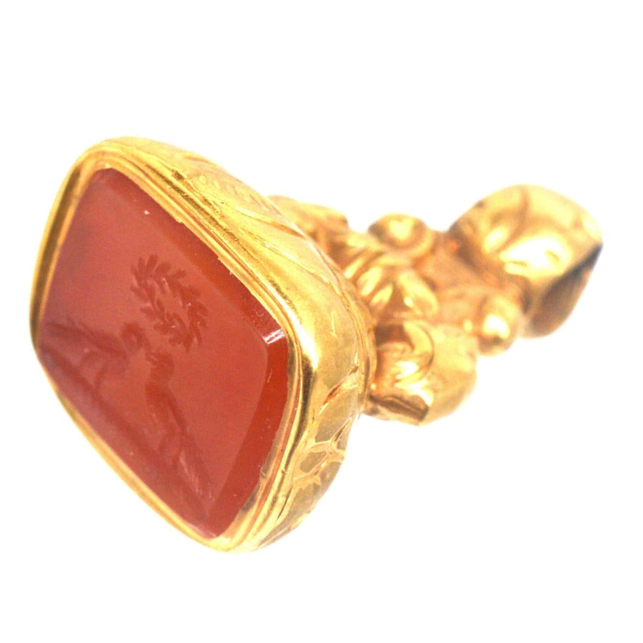 Regency gold cased seal featuring carnelian intaglio of two doves kissing under a love wreath, symbolizing eternal devotion.