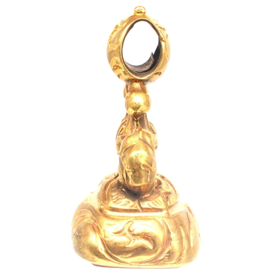 Regency gold cased seal with intricate design, featuring a carnelian intaglio of two doves kissing under a wreath.