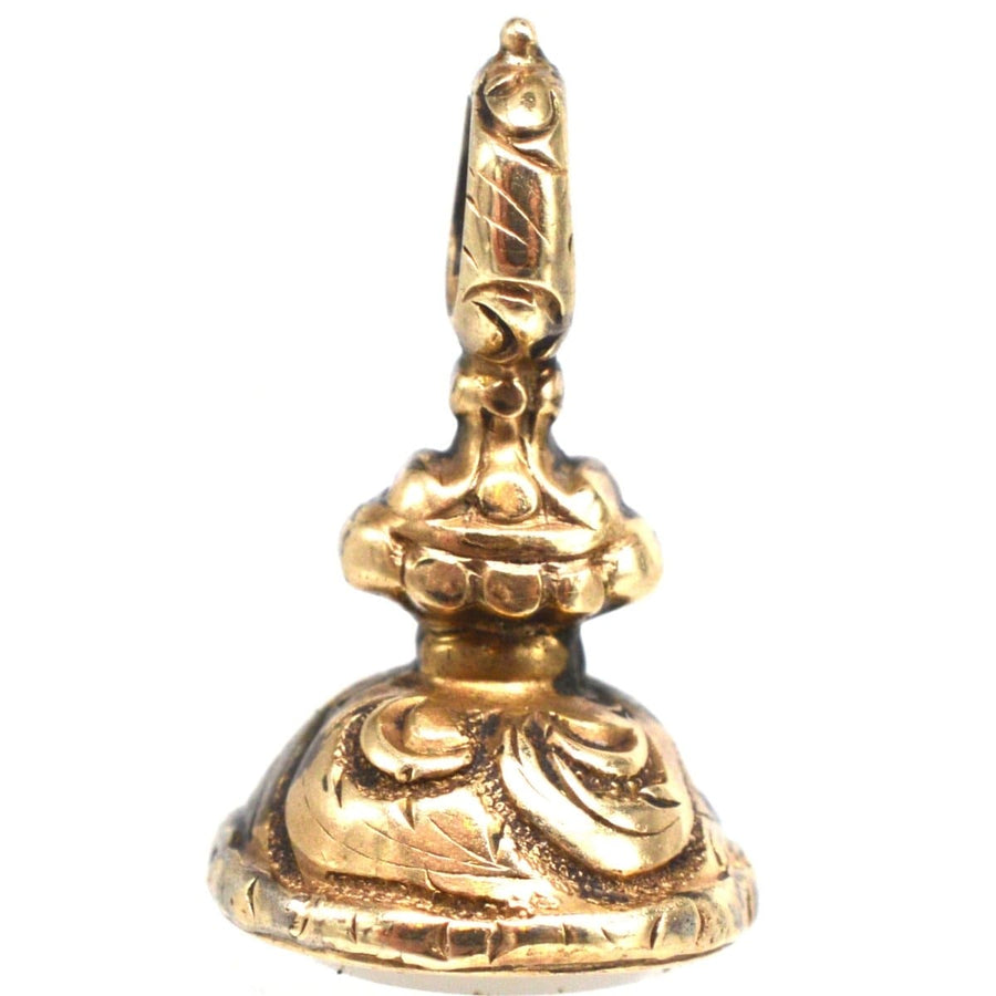 1820s Regency gold cased small seal charm with intricate repousse work and chalcedony base.