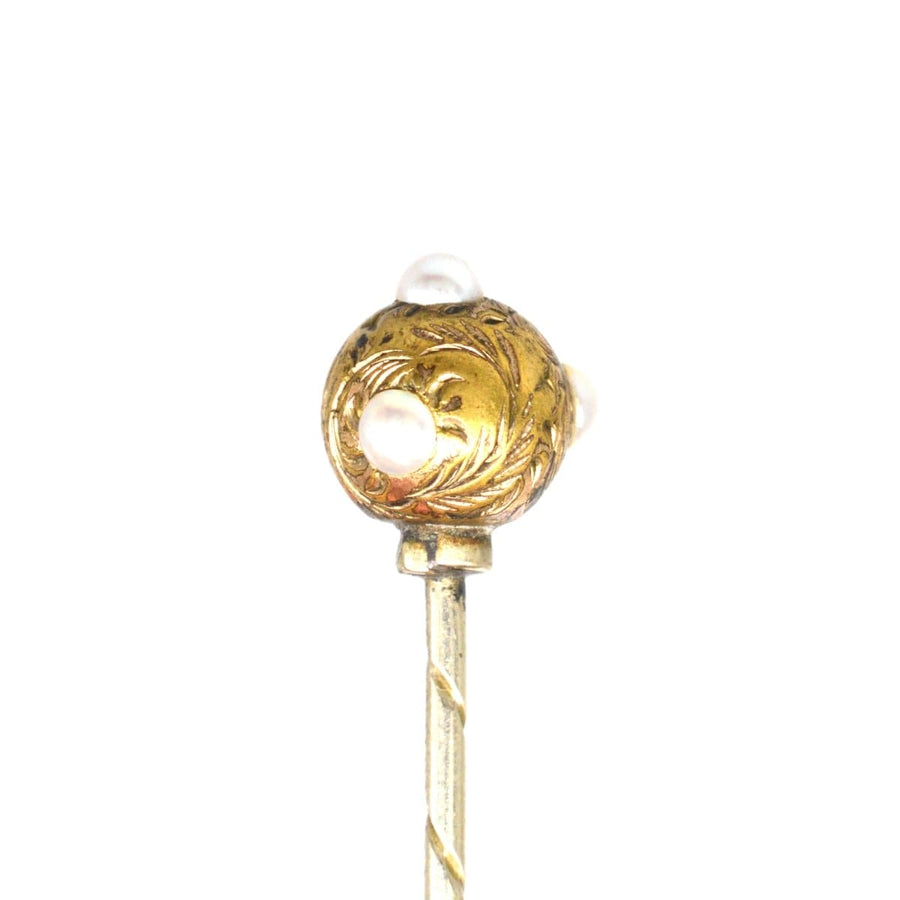 Regency pearl and gold ball tie pin from the 1820s-1840s with engraved swirling leaves.