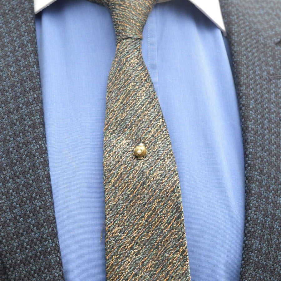 Regency pearl and gold ball tie pin featured on a patterned tie and collared shirt, showcasing vintage elegance.