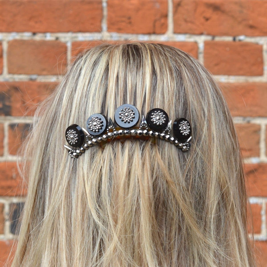 Regency Onyx and cut steel tiara on tortoiseshell comb worn in long hair with intricate detailing.
