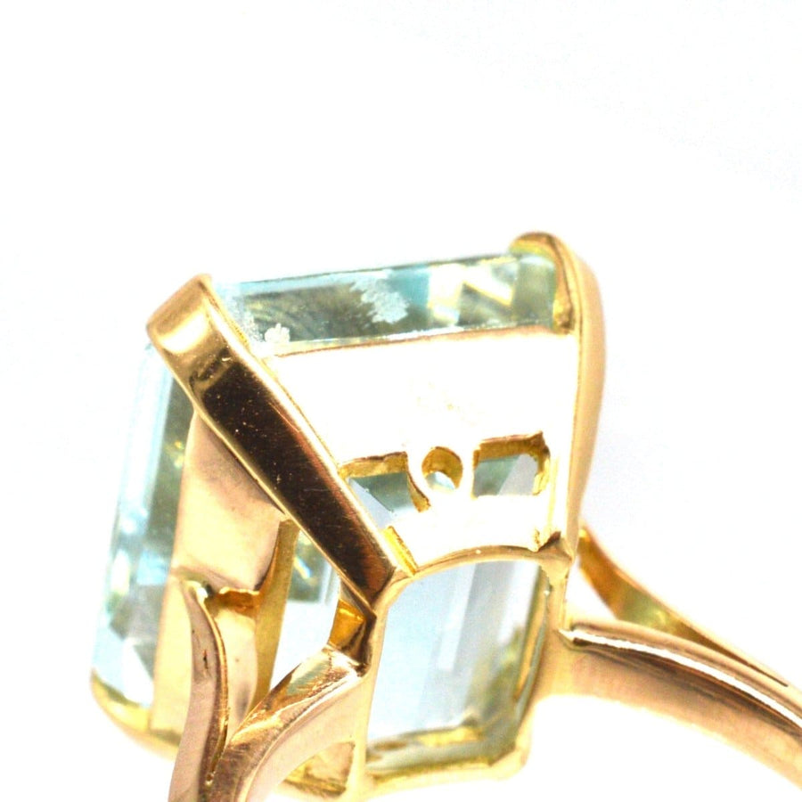Close-up of a retro 18ct gold aquamarine ring showcasing a large 12-carat aquamarine stone in a classy setting.