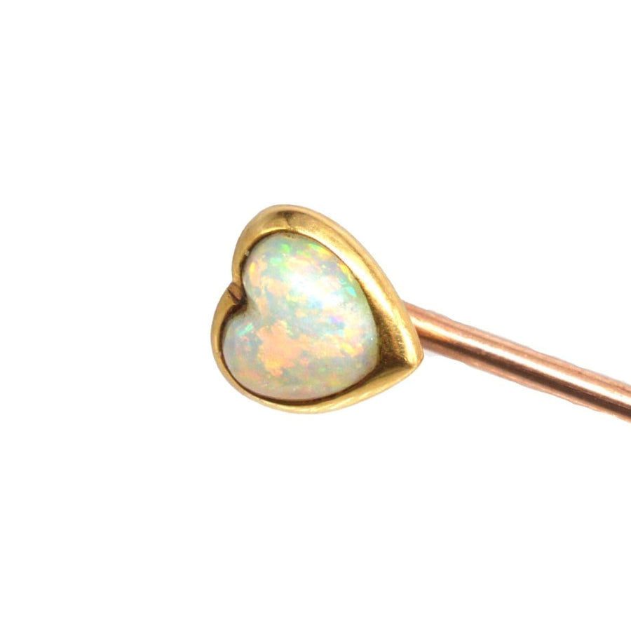 Small Edwardian 15ct gold tie pin with heart-shaped opal showcasing vibrant blue, green, and red colors.