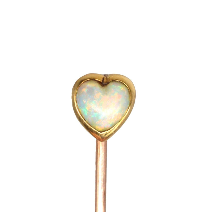 Small Edwardian 15ct gold tie pin featuring a heart-shaped opal that showcases vibrant colors.