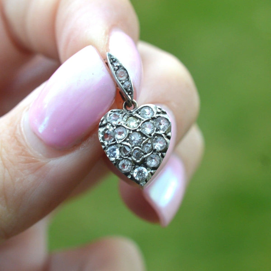 Small Edwardian gold and silver heart-shaped pendant set with paste, showcasing vintage charm and elegance.