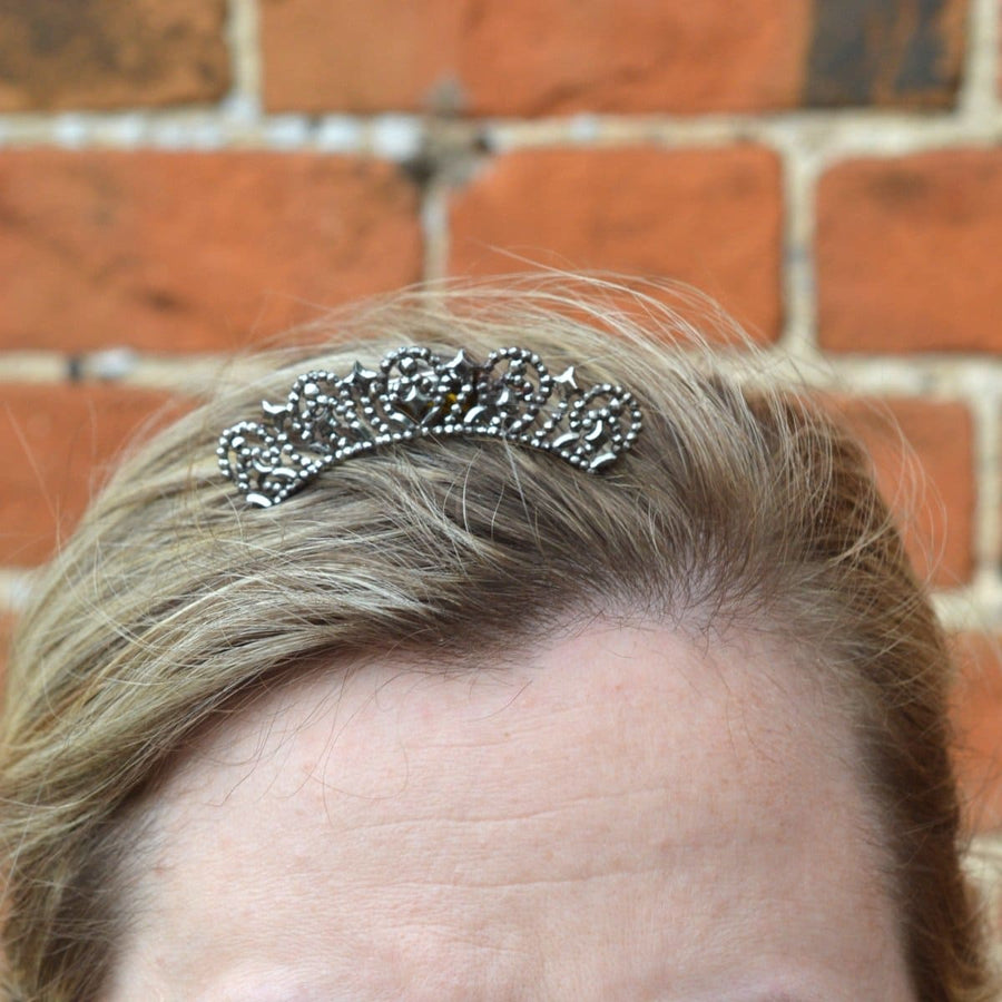 Small Regency cut steel tiara comb worn in hair, mimicking sparkle of rose cut diamonds, vintage elegance.