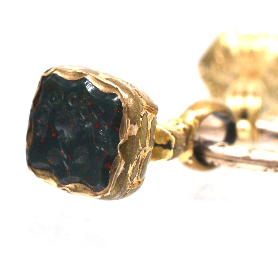 Close-up of early Victorian gold cased seal featuring a bloodstone with intricate design and split ring.