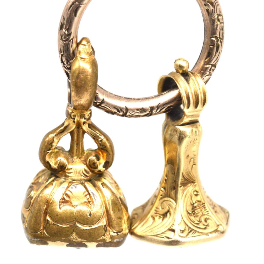 Two early Victorian gold cased seals featuring a hexagon citrine and a bloodstone with intricate designs.