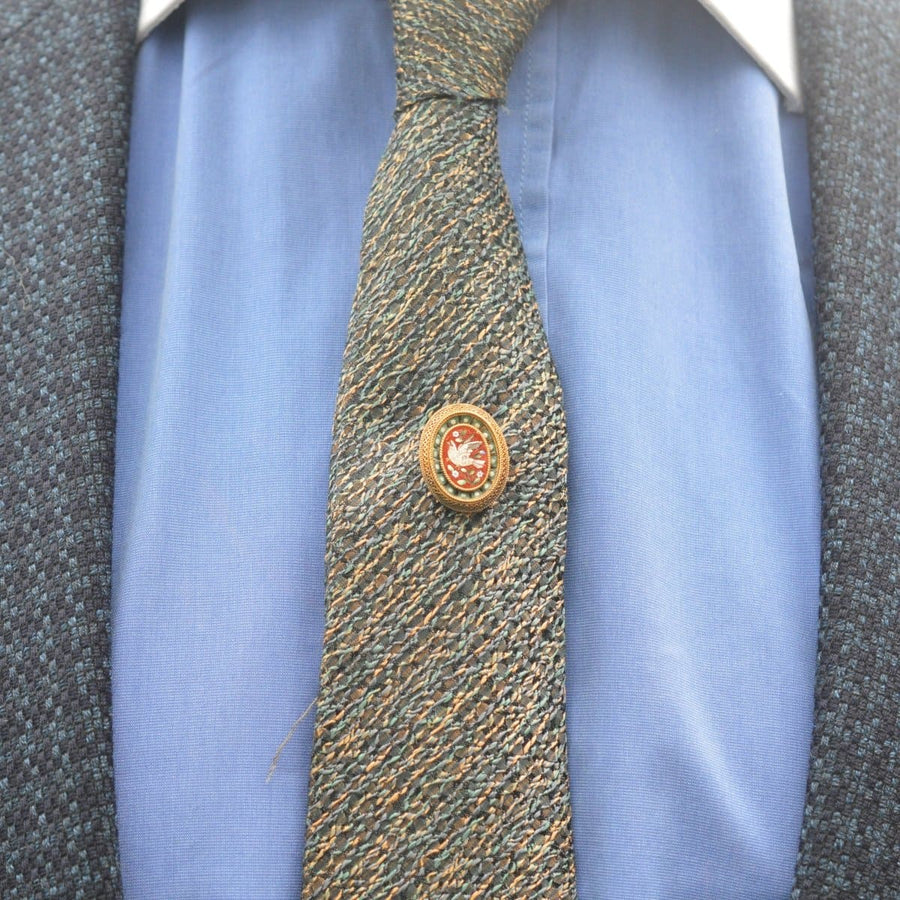 Victorian 15ct gold Etruscan micromosaic tie pin featuring a dove, worn on a textured tie.