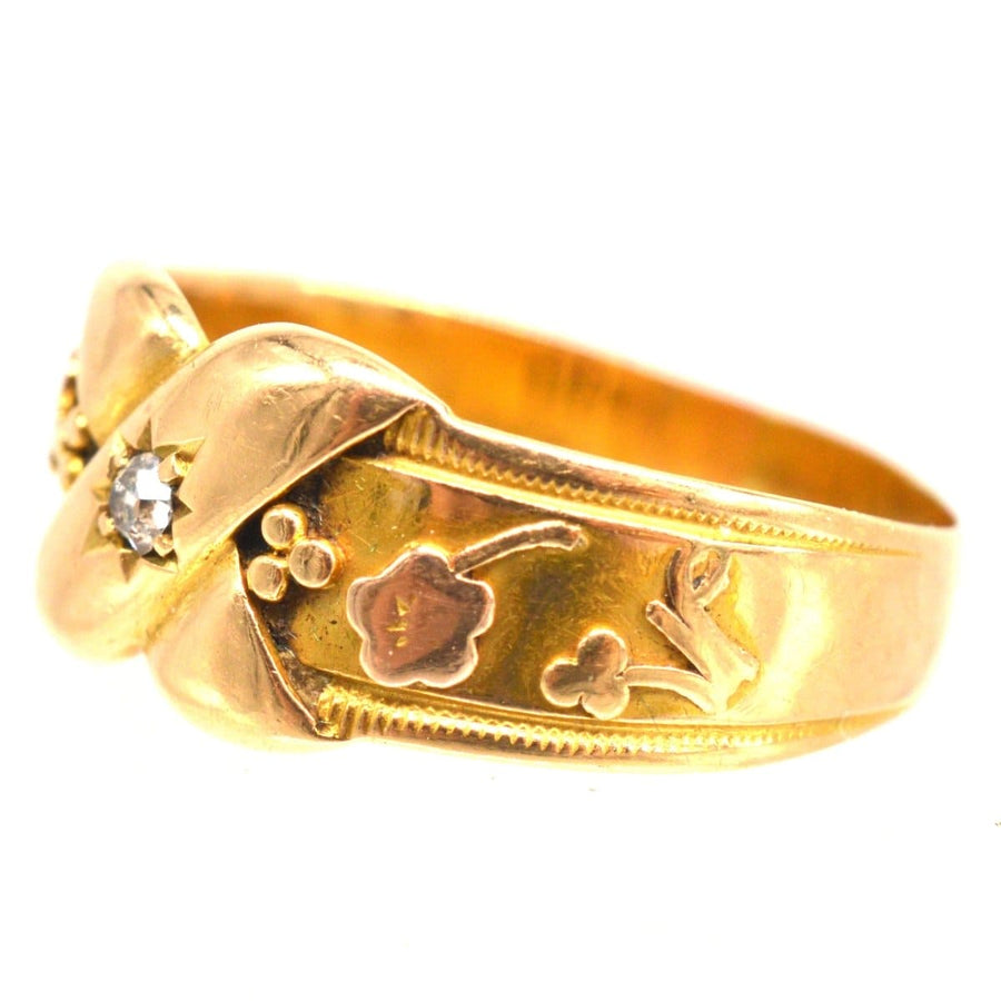Victorian 18ct gold 'Kiss' ring with diamond, featuring floral designs symbolizing love and new beginnings.