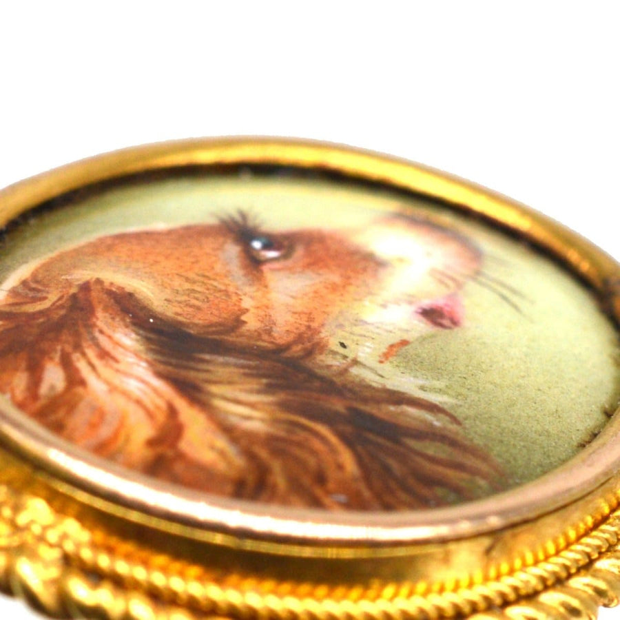 Victorian 18ct gold tie pin featuring a painted spaniel dog, showcasing meticulous artistry.